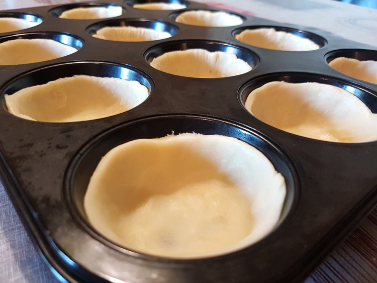 Mini quiches dough in tray